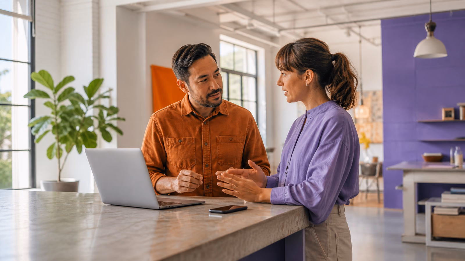 A small-business owner and strategist discuss practical website decisions in a bright service-business studio.